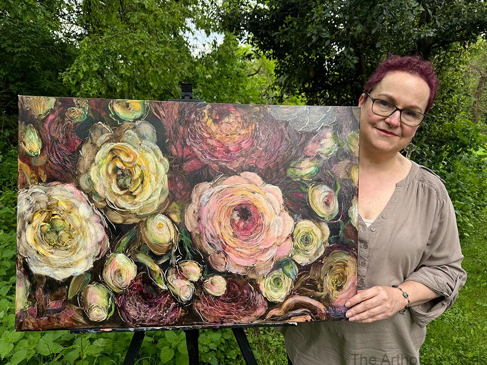 Gabrielle in the garden displaying her Rustic Bloom Oil Painting
