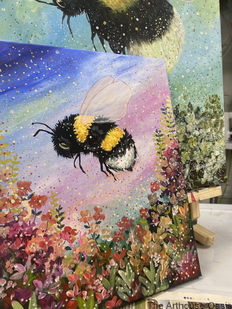 Canvas showing bumblebee painting in acrylics with flowers against the sky