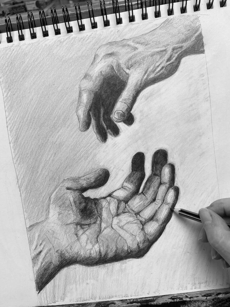 Realistic pencil drawing of two hands, one reaching and one open, with strong shading and texture.