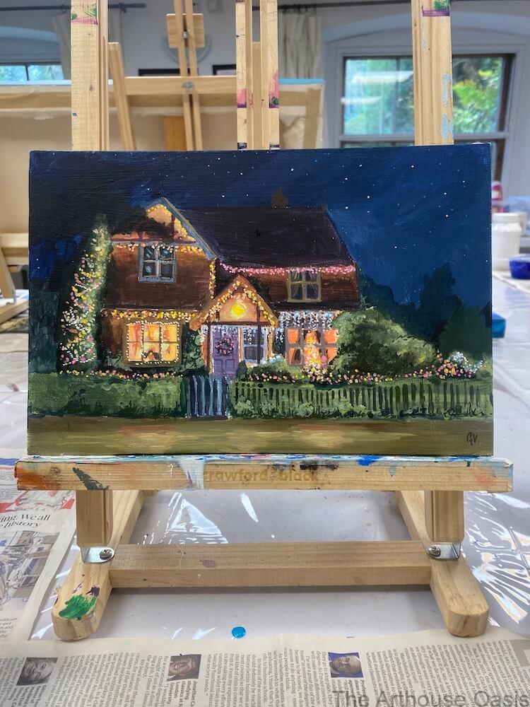 Acrylic painting of a family home at night decorated with Christmas lights, created as a festive card design.