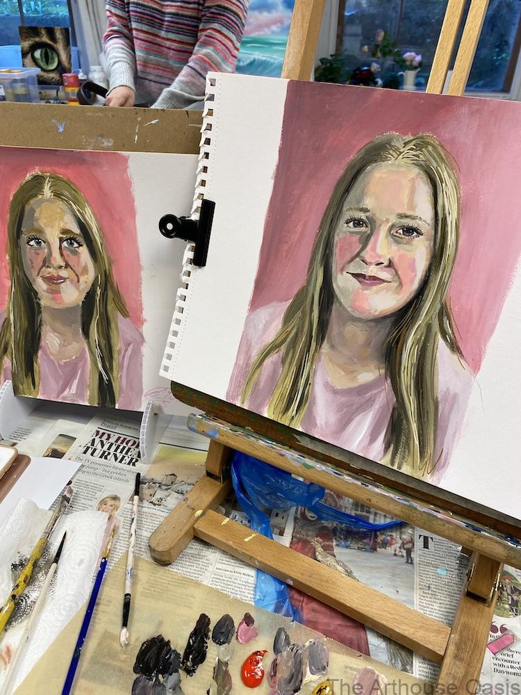 Finished student portrait paintings with pink backgrounds and expressive painterly style.