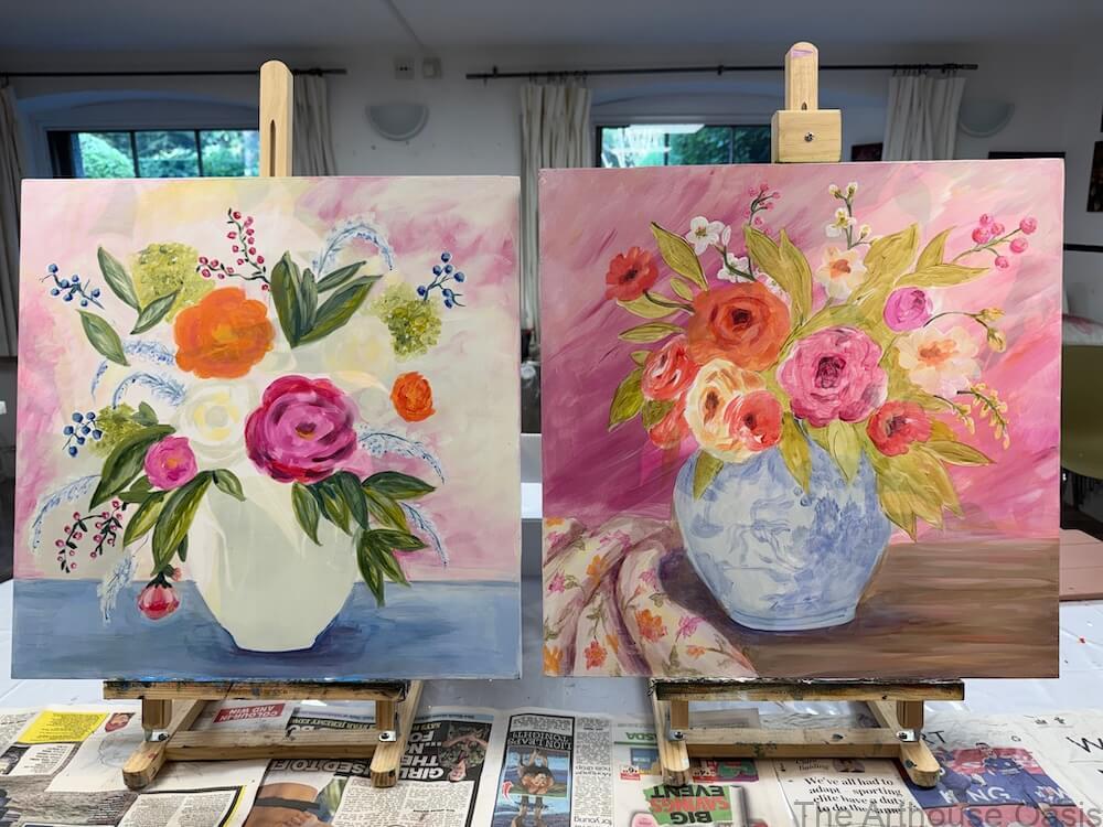 Two floral acrylic paintings in progress on easels in an art studio.