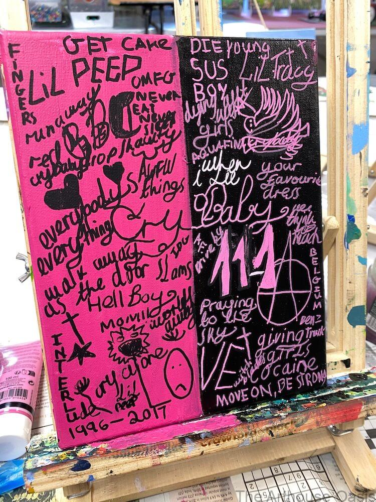 Pink and black mixed media canvas featuring handwritten lyrics, symbols and expressive typography created during a contemporary art class.